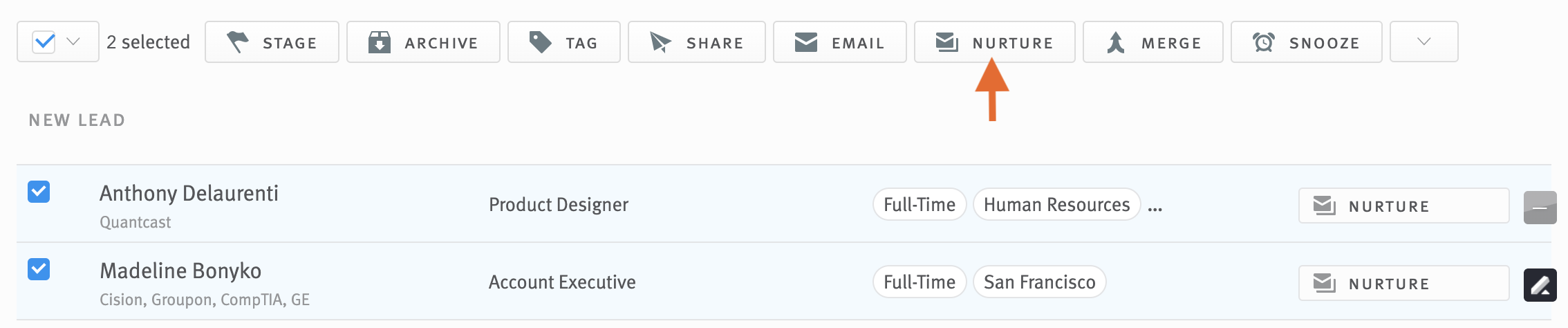 Two opportunities selected in opportunity list; arrow pointing Nurture button in bulk action toolbar.